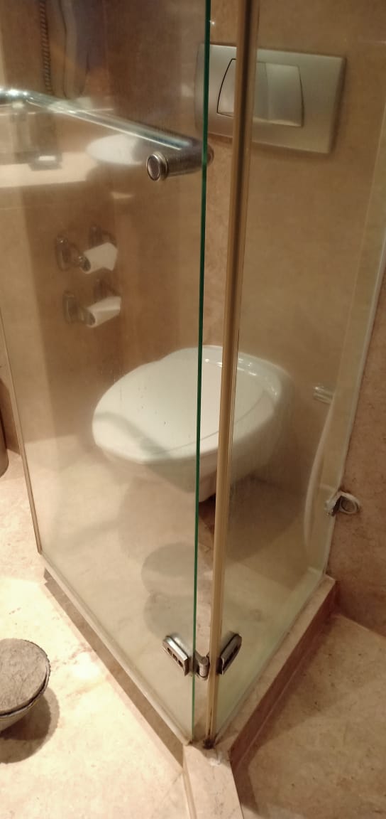 Glass shower cubicle before cleaning